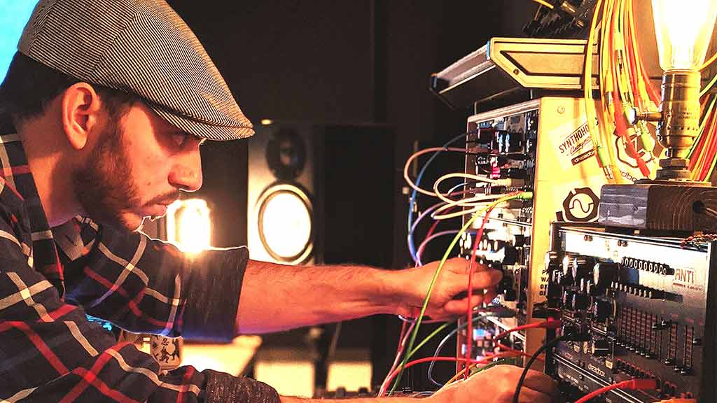 a photo of Dimitris Mann using his modular synth setup